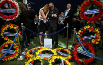 <p>Yael Pedazur, who works at the Peres Center for Peace, mourns beside the grave of former Israeli President Shimon Peres during the burial ceremony at his funeral at Mount Herzl Cemetery in Jerusalem on Sept. 30, 2016. (REUTERS/Ronen Zvulun) </p>