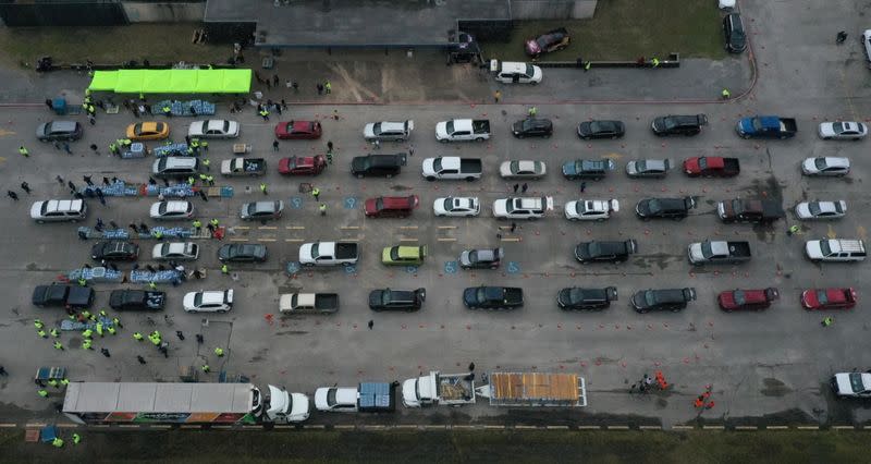 Residents line up to receive water following an unprecedented winter storm in Houston, Texas