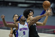 Detroit Pistons' Jerami Grant, left, and Cleveland Cavaliers' Jarrett Allen battle for a loose ball in the second half of an NBA basketball game, Wednesday, Jan. 27, 2021, in Cleveland. (AP Photo/Tony Dejak)