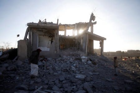 FILE PHOTO: People inspect damage at the site of a Saudi-led air strike, north of Yemen's capital Sanaa, March 8, 2018. REUTERS/Mohamed al-Sayaghi