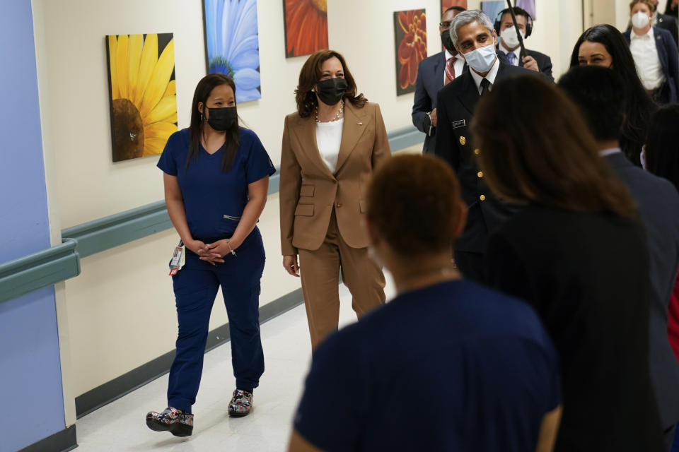 Vice President Kamala Harris, center, Surgeon General Vivek Murthy, right, and Joy Budd, Registered Nurse, Children's National Hospital, left, arrive to speak with member of the hospital staff during tour at Children's National Hospital, Monday, May 23, 2022. (AP Photo/ Carolyn Kaster)