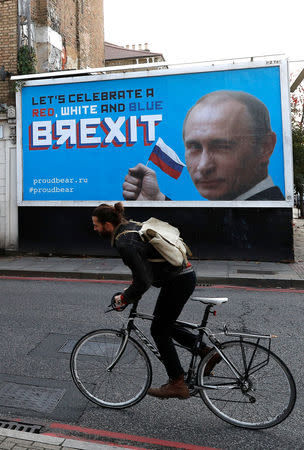 A man cycles past a billboard poster in London, Britain, November 8, 2018. REUTERS/Peter Nicholls