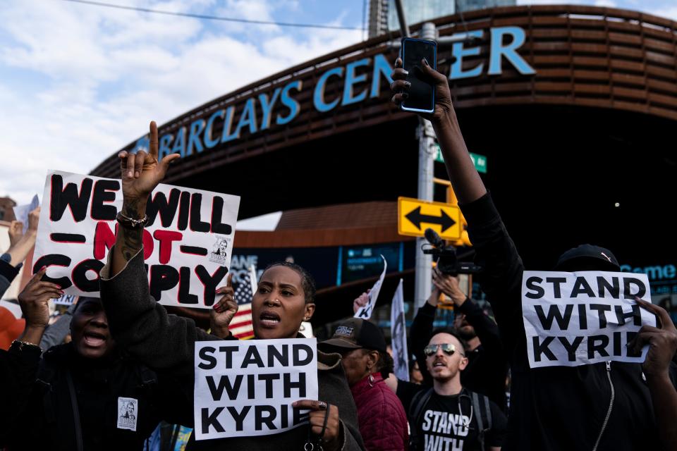 Protesters rally in support of Kyrie Irving outside Barclays Center.