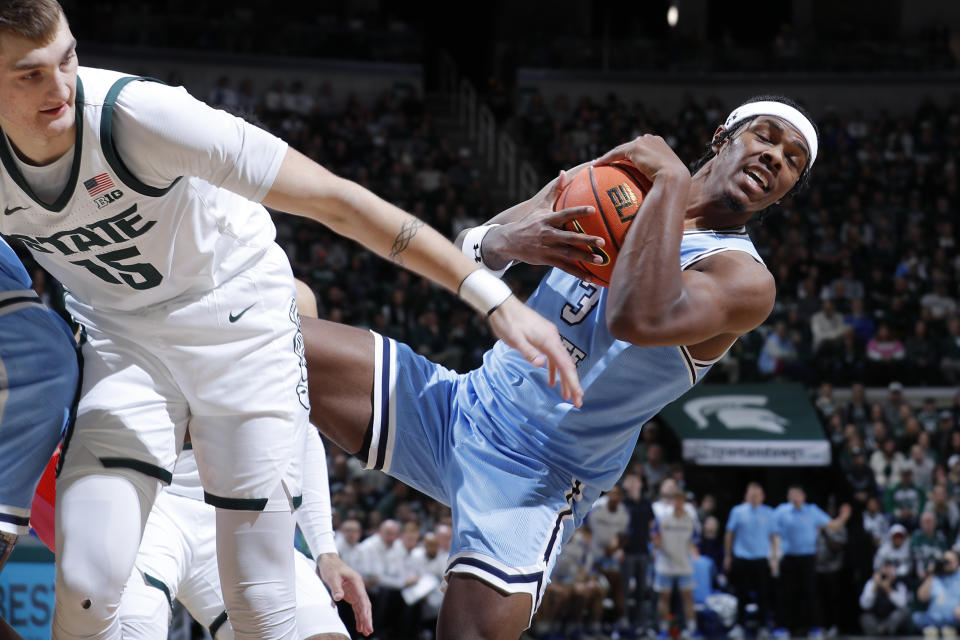 FILE - Indiana State guard Ryan Conwell (3), right, grabs a rebound against Michigan State center Carson Cooper (15) during an NCAA college basketball game, Saturday, Dec. 30, 2023, in East Lansing, Mich. The Sycamores (31-6) have spent all season proving people wrong. (AP Photo/Al Goldis, File)