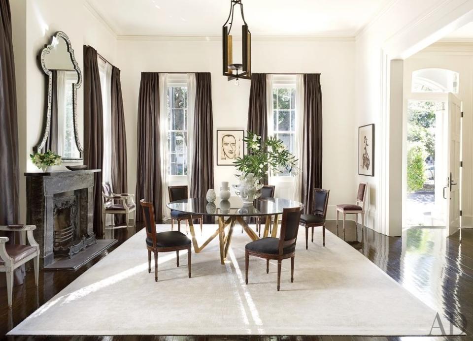 The dining room of a <a rel="nofollow noopener" href="https://www.architecturaldigest.com/story/lee-ledbetter-new-orleans-house-article?mbid=synd_yahoo_rss" target="_blank" data-ylk="slk:New Orleans home;elm:context_link;itc:0;sec:content-canvas" class="link ">New Orleans home</a> designed by Lee Ledbetter features a custom-made table, 1930s Jansen chairs from Florian Papp, and a Robert Gordy monotype; the wall is painted in Benjamin Moore's Cloud White.