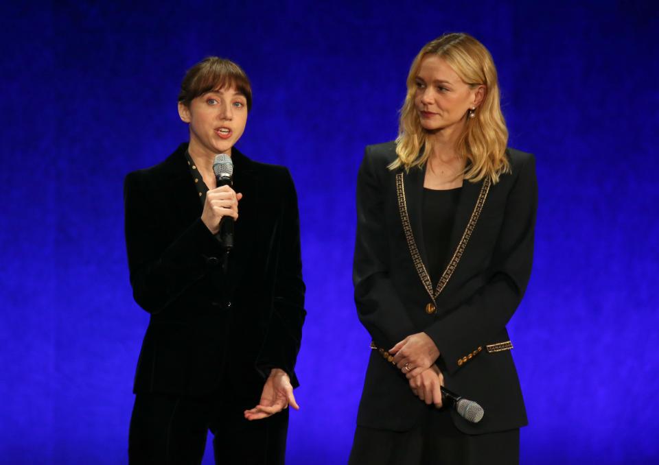 Zoe Kazan and Carey Mulligan holding microphones