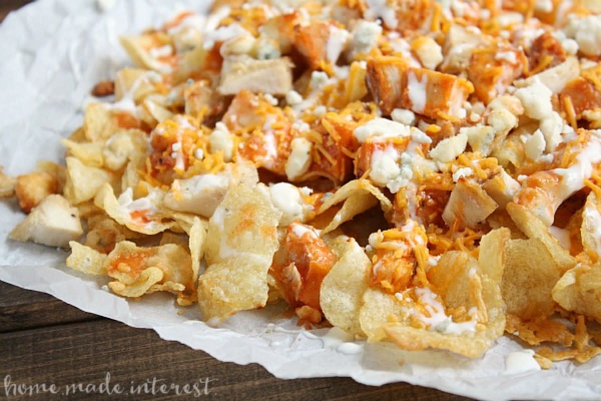 <p>Homemade Interest</p><p>All you need to make these outrageously good nachos is crunchy kettle chips, tangy buffalo sauce, and blue cheese.</p><p><strong>Get the recipe: <a href="http://www.homemadeinterest.com/buffalo-chicken-nachos/" rel="nofollow noopener" target="_blank" data-ylk="slk:Buffalo Chicken Nachos;elm:context_link;itc:0;sec:content-canvas" class="link rapid-noclick-resp">Buffalo Chicken Nachos</a></strong></p>
