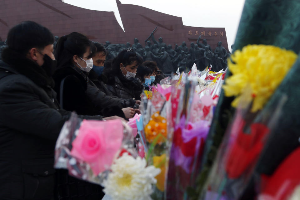 Citizens lay bouquets of flowers at the bronze statues of their late leaders Kim Il Sung and Kim Jong Il on Mansu Hill in Pyongyang, North Korea Thursday, Dec. 16, 2021, on the occasion of 10th anniversary of demise of Kim Jong Il. (AP Photo/Cha Song Ho)