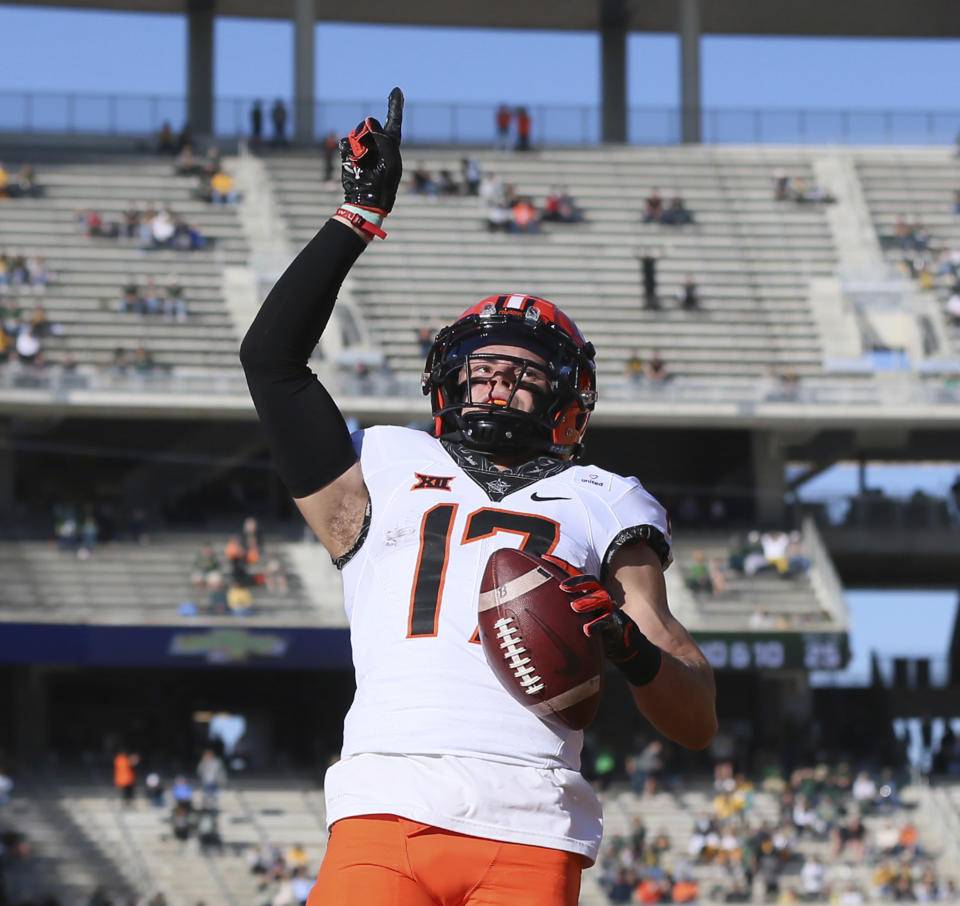 Oklahoma State wide receiver Dillon Stoner points skyward after scoring against Baylor in the first half of an NCAA college football game, Saturday, Dec. 12, 2020, in Waco, Texas. (Rod Aydelotte/Waco Tribune-Herald via AP)
