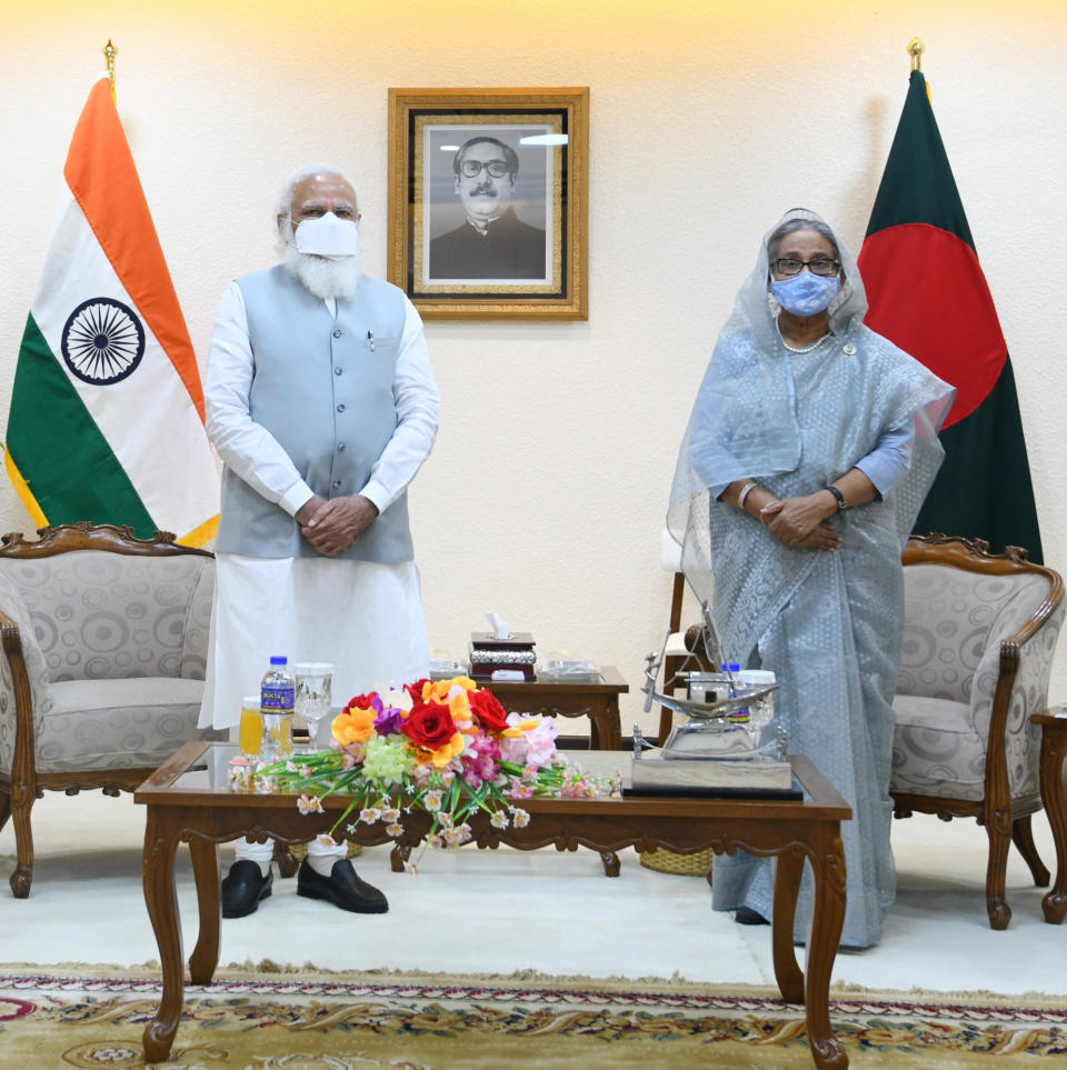 In this photo provided by Prime Minister of India Narendra Modi's twitter handle, Indian Prime Minister Narendra Modi and Bangladesh's Prime Minister Sheikh Hasina stands for a photograph in Dhaka, Bangladesh, Friday, March 26, 2021. Modi on Saturday concluded his two-day official visit to Bangladesh amid both violent protests and enthusiasm that the bilateral relations between the two neighbors would continue to grow. (Prime Minister of India Narendra Modi's twitter handle via AP Photo)