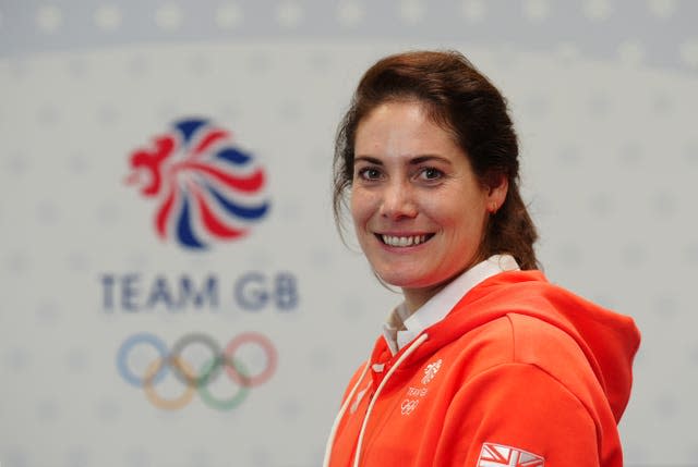 Kate French poses in front of a Team GB logo. 