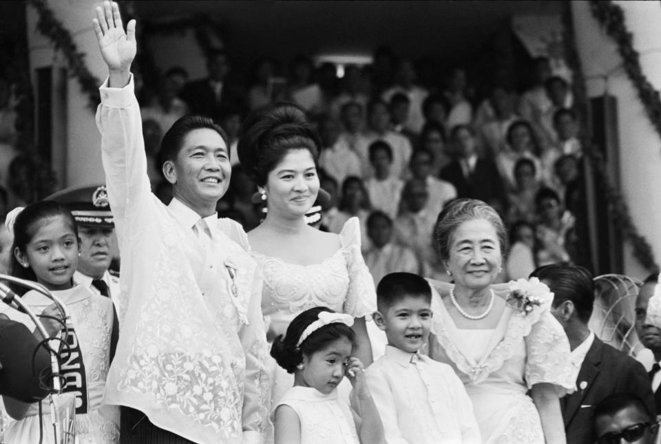 Standing with his family, Ferdinand Marcos Sr. waves to the crowd after his inauguration as the President of the Philippines on December 30, 1965