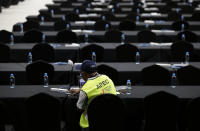 A journalist works at the APEC 2018 International Media Center in Port Moresby, Papua New Guinea Wednesday, Nov. 14, 2018. After three decades of promoting free trade as a panacea to poverty, the APEC grouping of nations that includes the U.S. and China is holding its lavish annual leaders meeting in the country that can least afford it. (AP Photo/Aaron Favila)