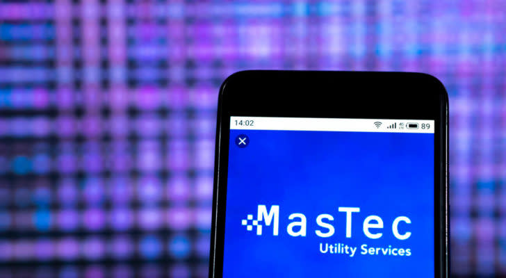 An image of a smart phone displaying the logo for "MasTec Utility Services" with a blue background and lots of purple and pink dots blurred out behind.