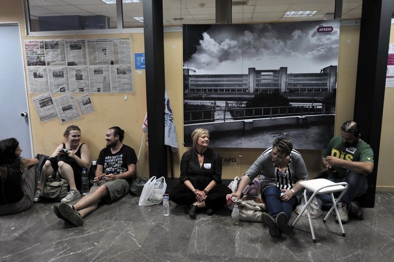 People stage a sit-in at the headquarters of the Greek state TV headquarters in Athens on June 12, 2013. Thousands of demonstrators took to the streets as workers staged a nationwide strike to protest against the government's dramatic shutdown of the public broadcaster ERT