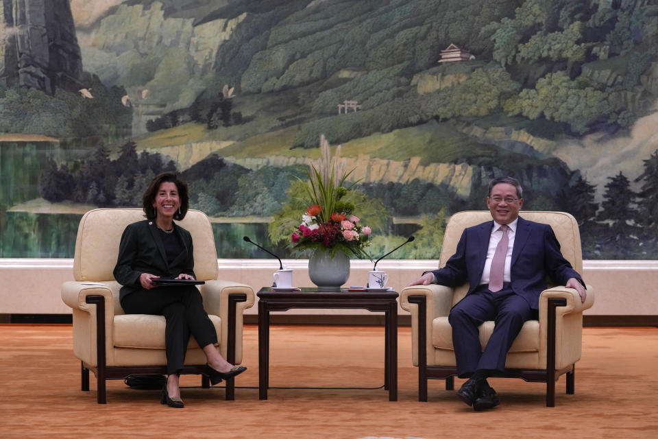 FILE - U.S. Commerce Secretary Gina Raimondo, left, and Chinese Premier Li Qiang have a light moment during a meeting at the Great Hall of the People in Beijing on Aug. 29, 2023. (AP Photo/Andy Wong, Pool, File)