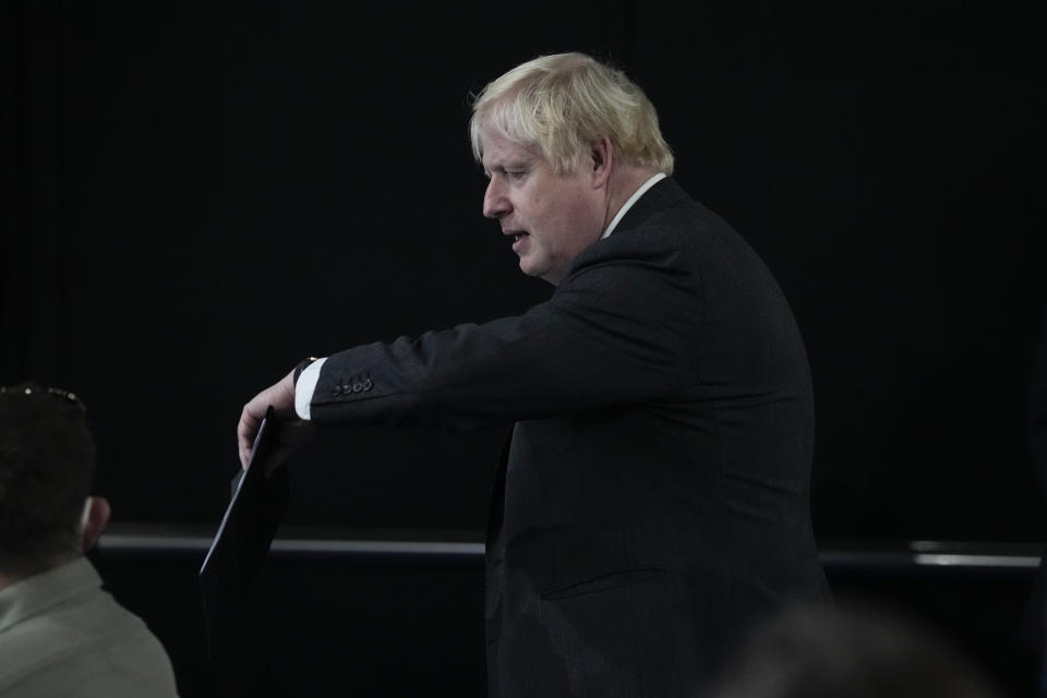 British Prime Minister Boris Johnson looks at his watch as he arrives for a press conference at the La Nuvola conference center for the G20 summit in Rome, Sunday, Oct. 31, 2021. Leaders of the world's biggest economies made a compromise commitment Sunday to reach carbon neutrality "by or around mid-century" as they wrapped up a two-day summit that was laying the groundwork for the U.N. climate conference in Glasgow, Scotland. (AP Photo/Kirsty Wigglesworth)