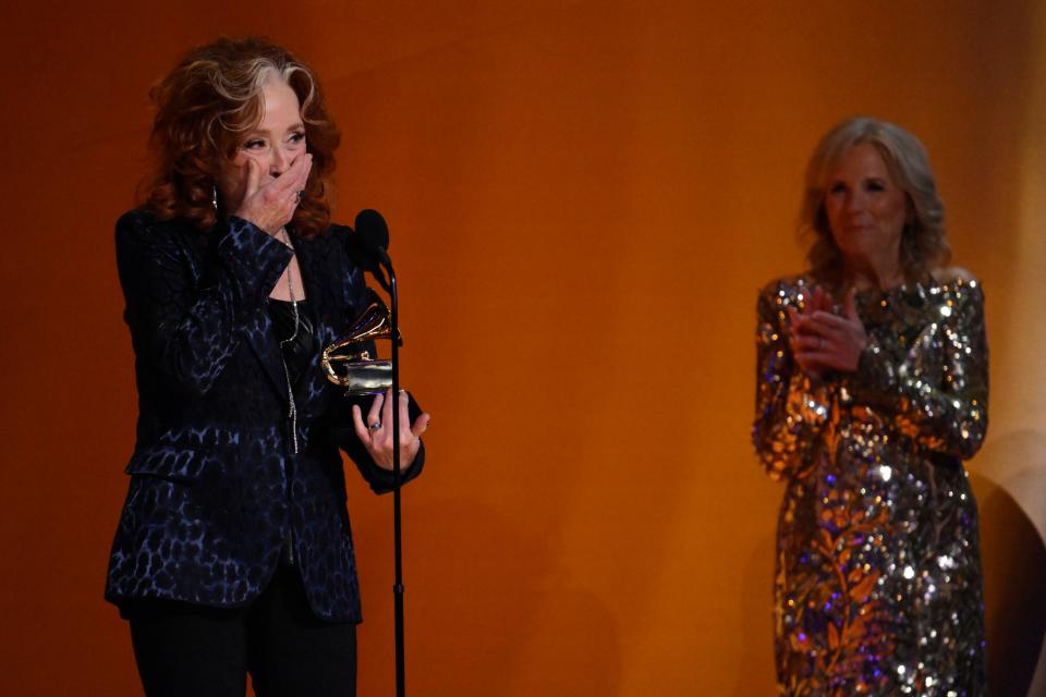 A surprised Bonnie Raitt accepts the award for song of the year for “Just Like That” as first lady Jill Biden looks on.