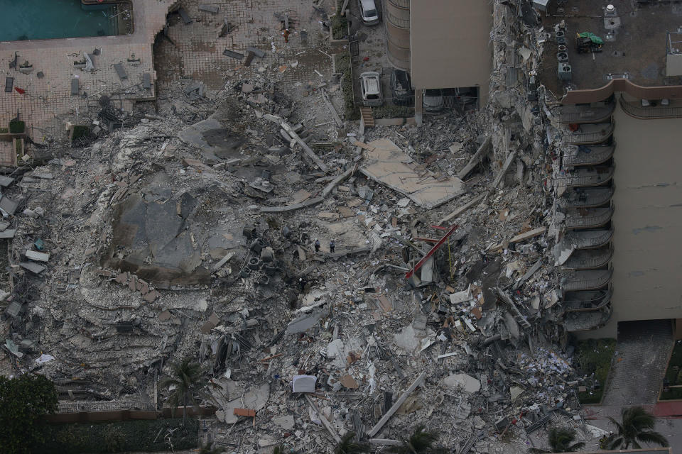 Search and rescue personnel work in the rubble of the 12-story condo tower that crumbled to the ground in Surfside on June 24, 2021.<span class="copyright">Joe Raedle—Getty Images</span>
