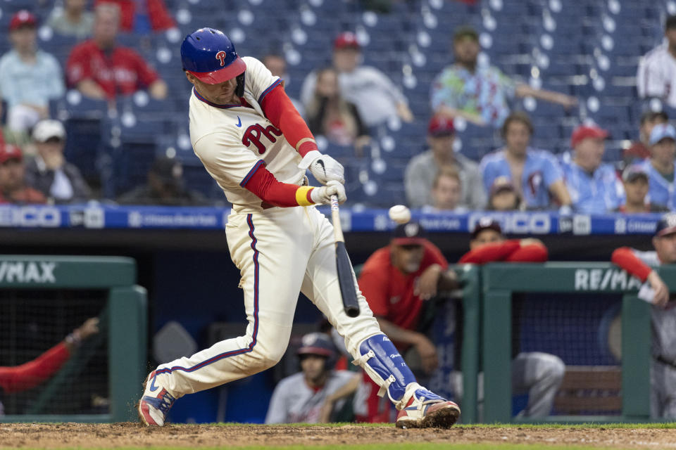 Philadelphia Phillies' Rhys Hoskins hits a three-run home run during the fifth inning of a baseball game against the Washington Nationals, Sunday, Sept. 11, 2022, in Philadelphia. (AP Photo/Laurence Kesterson)