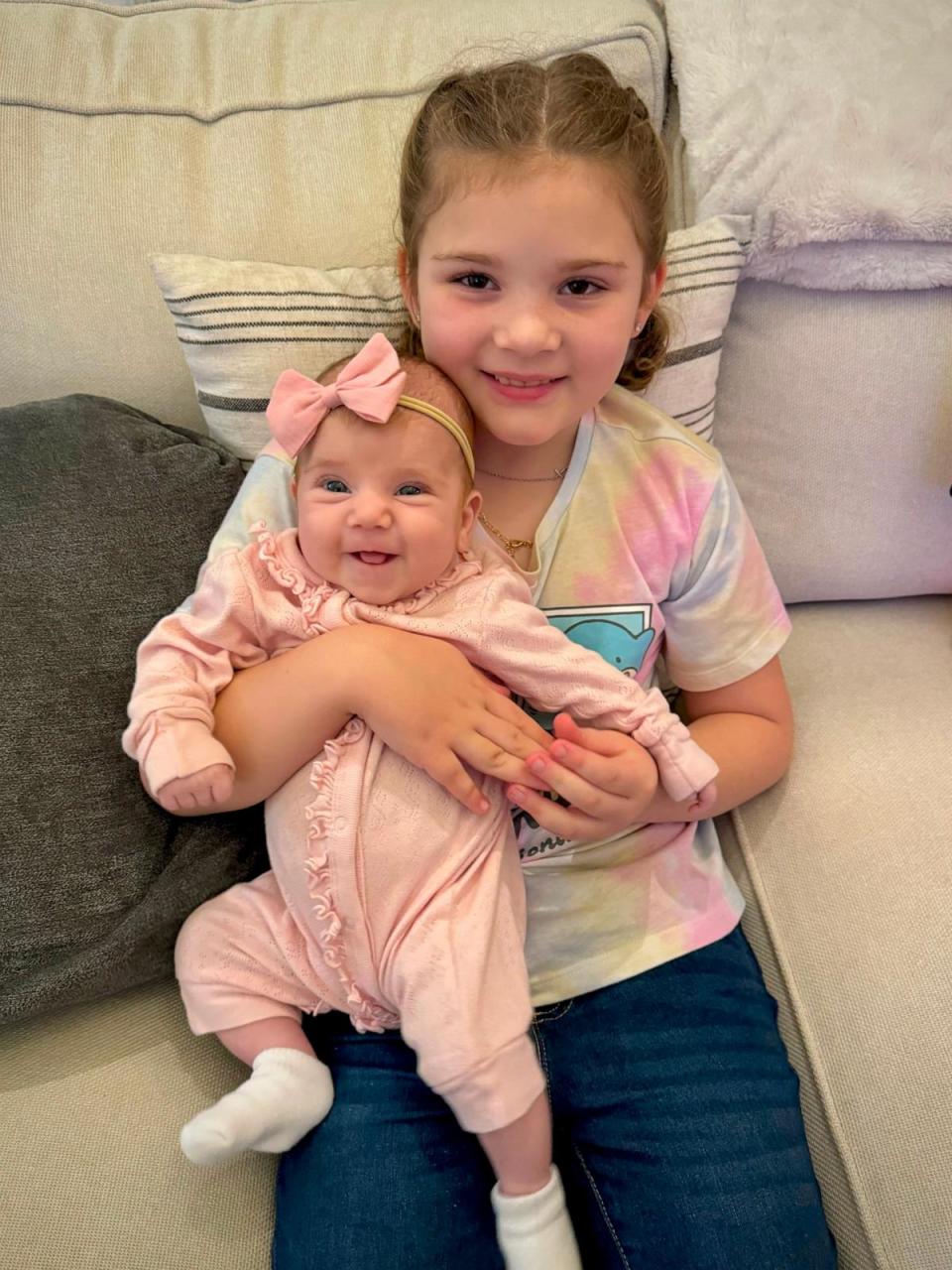 PHOTO: Sophia, 8, holds her younger sister Brynlee, 3 months. (Courtesy of Ashley Cunningham)