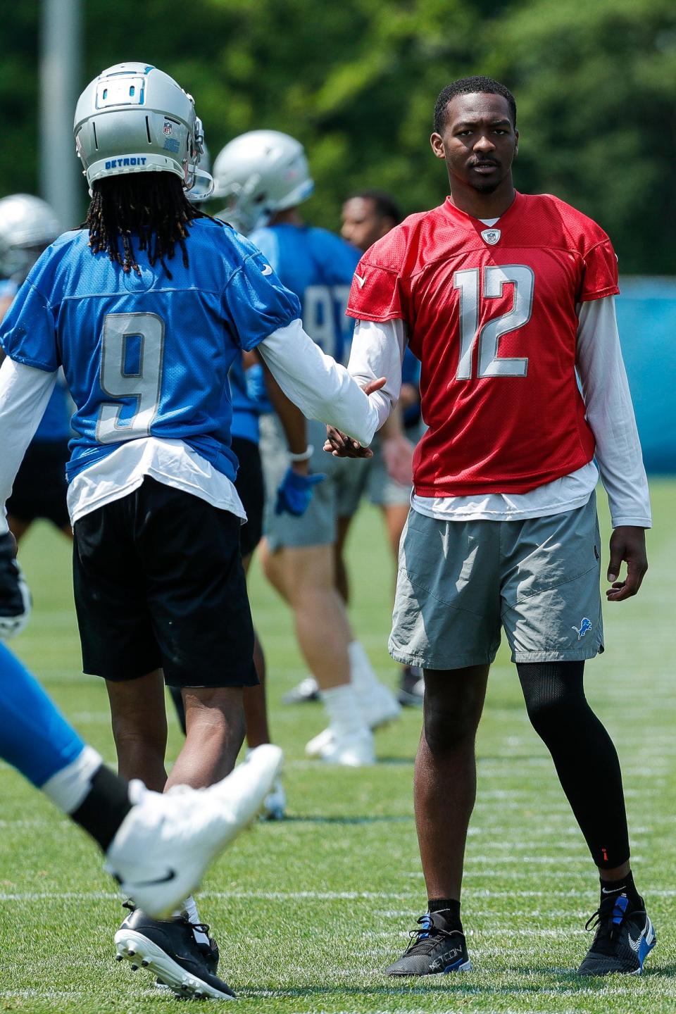 Lions quarterback Hendon Hooker, right, shakes hands with wide receiver Jameson Williams minicamp at in Allen Park on Wednesday, June 7, 2023.