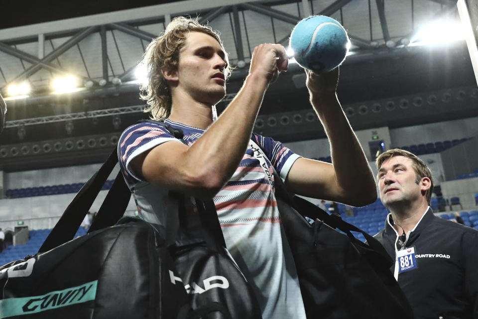 Germany's Alexander Zverev signs autographs after defeating Italy's Marco Cecchinato in their first round singles match at the Australian Open tennis championship in Melbourne, Australia, Tuesday, Jan. 21, 2020. (AP Photo/Dita Alangkara)