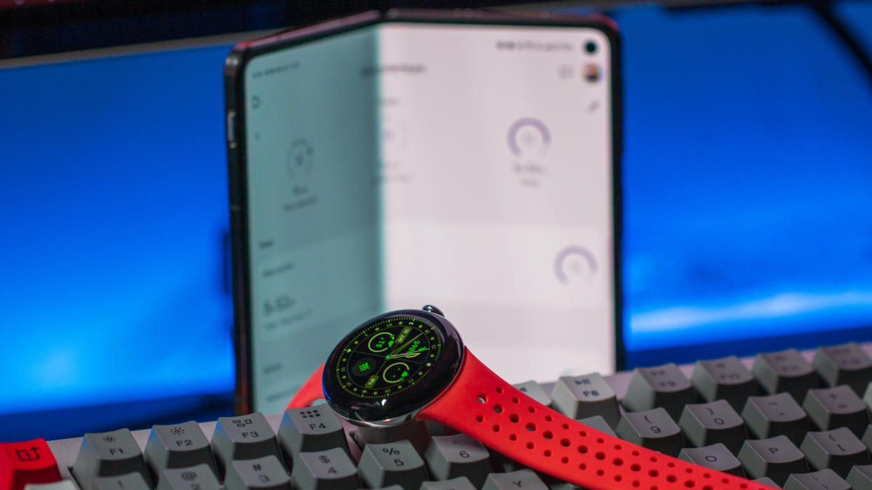  Pixel Watch 2 on keyboard with OnePlus Open in the background. 