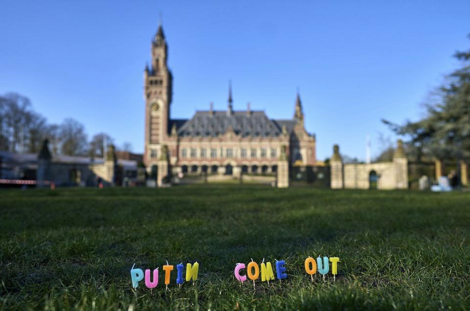 Candles are set in the grass that spell out ‘Putin Come Out’ in front of the International Criminal Court in The Hague, Netherlands in March 2022. (AP Photo/Phil Nijhuis)