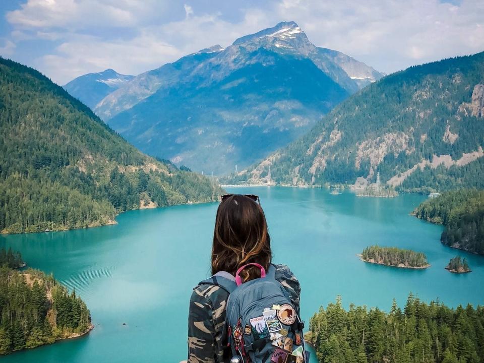 A woman standing in front of a lake in North Cascades National Park.