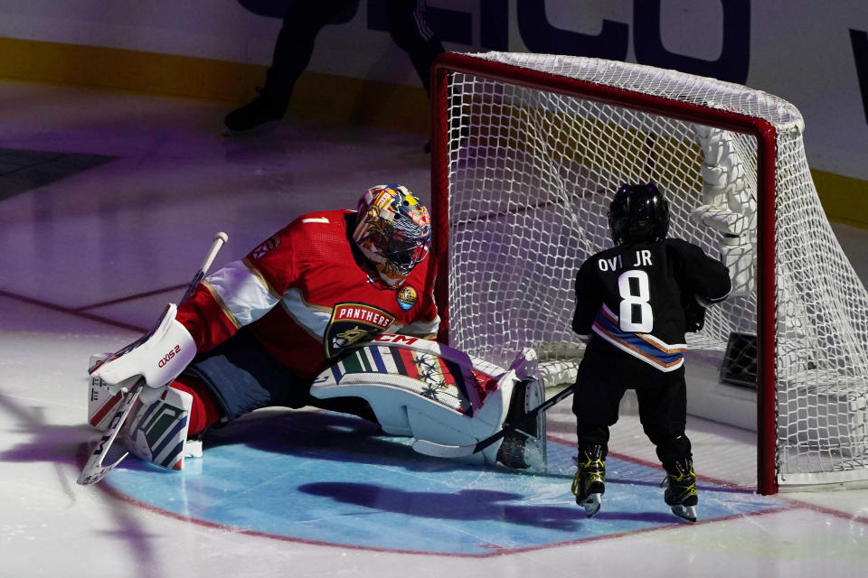 Former Florida Panthers goaltender Roberto Luongo attempts to stop a shot on goal by Sergei Ovechkin, 4, son of Washington Capitals' Alex Ovechkin, during the NHL All Star Skills Showcase,Friday, Feb. 3, 2023, in Sunrise, Fla. (AP Photo/Marta Lavandier)