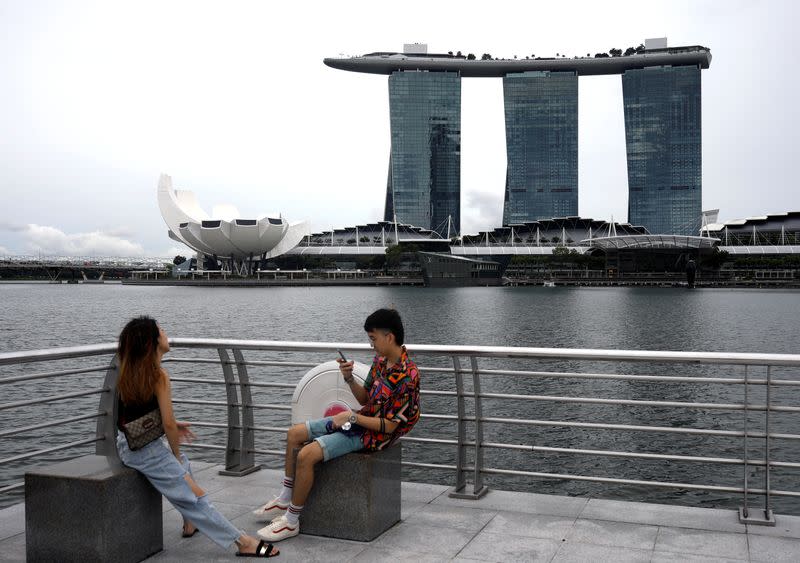 Youth takes photos at Merlion Park in Singapore