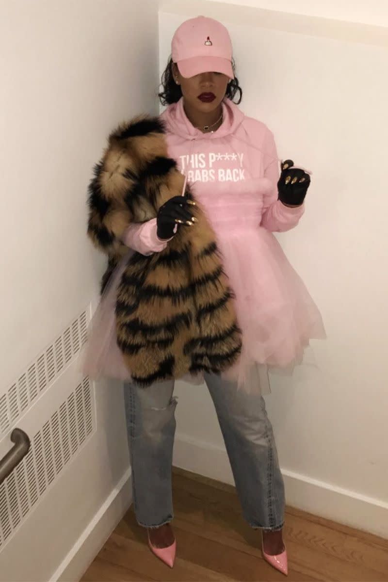 <p>In a pink "This P***y Grabs Back" hoodie, tutu, patent leather pumps and dad hat, jeans, striped fur stole and fingerless gloves for the Women's March in New York.</p>