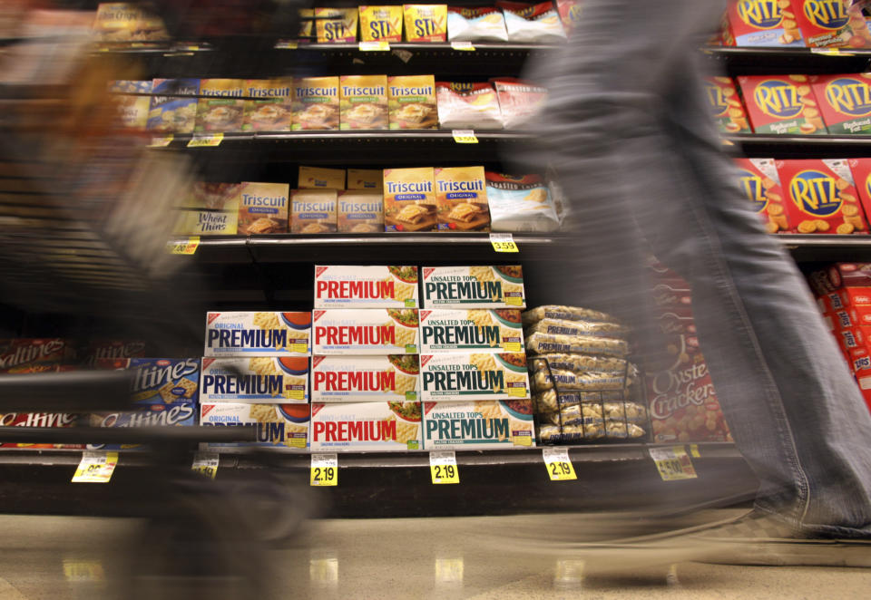 FILE - In this Feb. 9, 2011, file photo, a shopper passes a shelf of crackers and other items at a Ralphs Fresh Fare supermarket in Los Angeles. The supermarket is one of the most important places to be shopping-savvy. The good news is that there are so many easy and effective way to slash your grocery budget. (AP Photo, File)