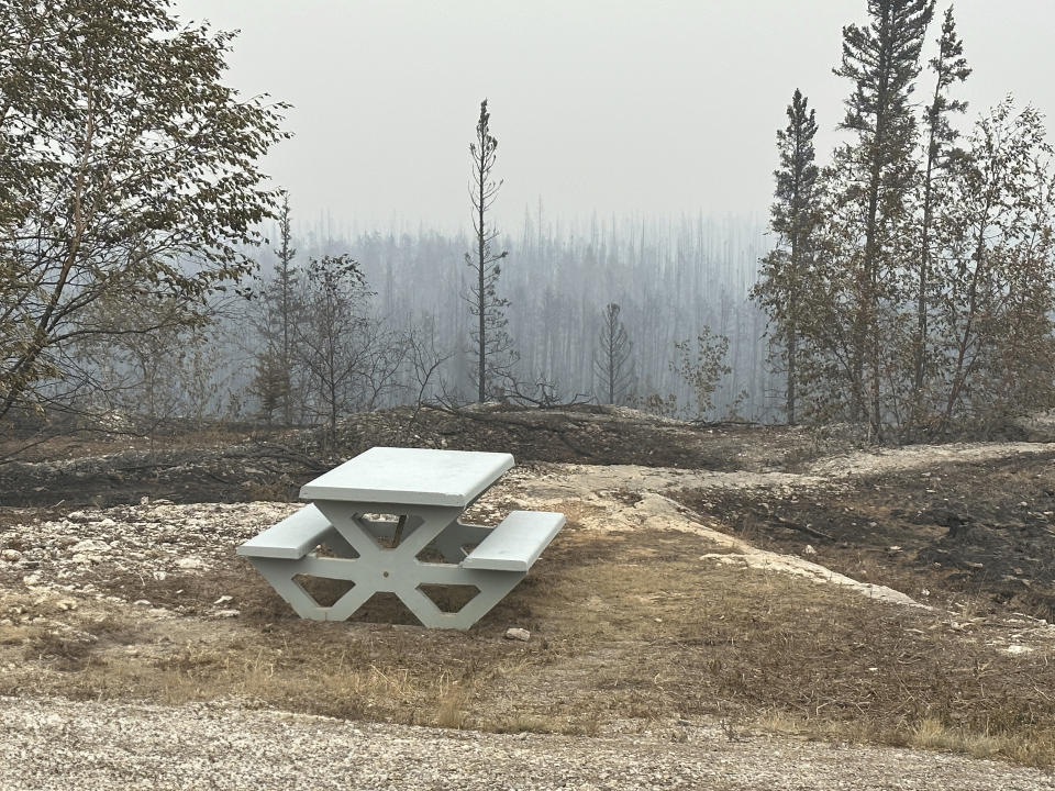 Damage from the wildfires is shown on Tuesday, Aug. 15, 2023 between Enterprise and Kakisa, Northwest Territories, Canada. Thousands of people in eight other communities, have already been forced to evacuate their homes, including the small community of Enterprise, where 80% of the town was destroyed. Officials said everyone made it out alive. (Ryan Planche via AP)