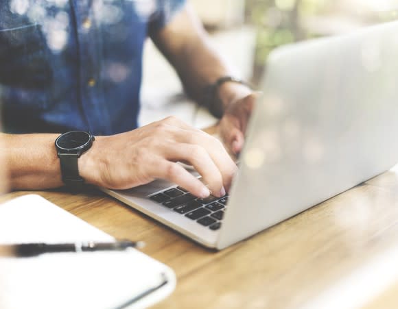 Man typing on laptop