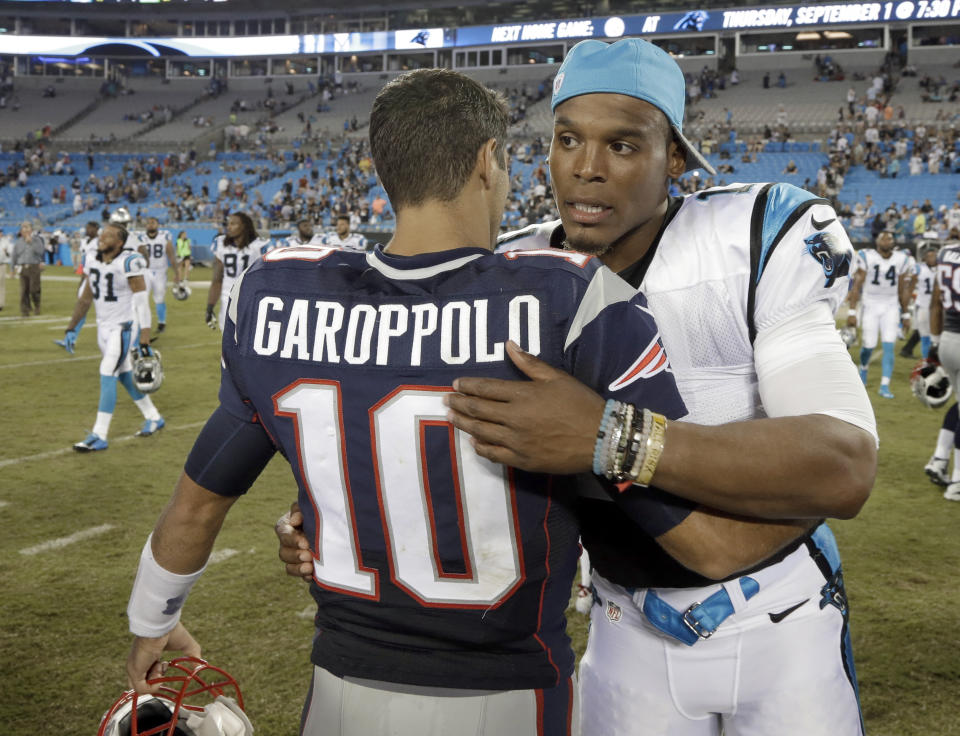 FILE - In this Aug, 26, 2016, file photo, then-New England Patriots' Jimmy Garoppolo, left, and then-Carolina Panthers' Cam Newton, right, hug after a preseason NFL football game in Charlotte, N.C. When quarterback Jimmy Garoppolo was Tom Brady’s backup in New England, his teammates used to call him “a gamer” because of his ability to keep plays alive in the pocket and make throws under pressure. Now the player who was long assumed to be Brady’s heir apparent returns to face his former team for the first time since being traded to the 49ers. He’ll be trying to add to the recent struggles of Patriots team now led by Cam Newton that is below .500 through five games for the first time since 2001. (AP Photo/Bob Leverone, File)