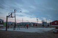 A group of youths play basketball just before midnight, ahead of the Toronto Raptors' Game 5 NBA finals game against the Golden State Warriors, about 400 km (250 miles) south of the Arctic Circle in Rankin Inlet, Nunavut, Canada June 9, 2019. Picture taken June 9, 2019. REUTERS/Cody Punter