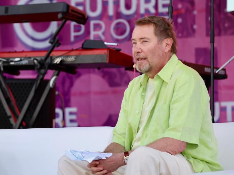 Jeffrey Gundlach, wearing a lime green shirt and tan pants, speaks at the Future Proof festival in Huntington Beach, California