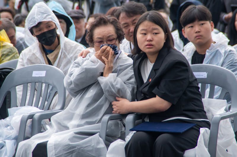A girl comforts her crying grandmother during the 76th anniversary of the Jeju 4.3 memorial ceremony at the Jeju 4.3 Peace Park in Jeju City, South Korea, on Wednesday. Photo by Darryl Coote/UPI