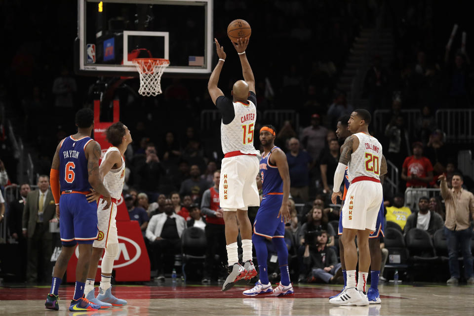 Atlanta Hawks guard Vince Carter (15) hits a three-point basket in the final seconds of an NBA basketball game against the New York Knicks Wednesday, March 11, 2020, in Atlanta. (AP Photo/John Bazemore)