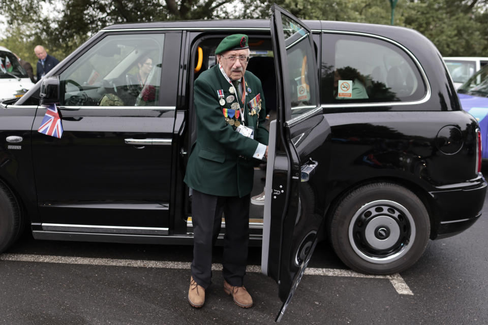 British veteran Richard Forrester of the Kings Royal Rifle Corps arrives in a British Taxi Charity for Military Veterans at the ceremony at Pegasus Bridge, in Ranville, Normandy, Sunday, June, 5, 2022. On Monday, the Normandy American Cemetery and Memorial, home to the gravesites of 9,386 who died fighting on D-Day and in the operations that followed, will host U.S. veterans and thousands of visitors in its first major public ceremony since 2019. (AP Photo/Jeremias Gonzalez)