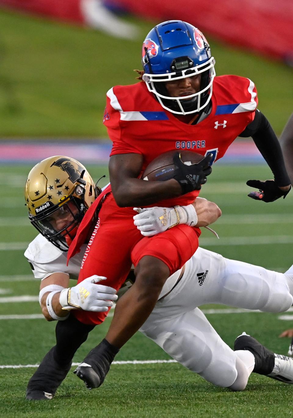 Cooper's  Zavian Alexander is tackled by Eagles linebacker Bryce Neves during the Crosstown Showdown on Sept. 1 at Shotwell Stadium.