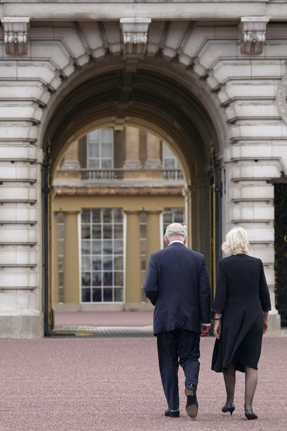 Britain's King Charles III, left, and Camilla, the Queen Consort, walk across the forecourt of Buckingham Palace, as he enters the palace for the first time as king, following Thursday's death of Queen Elizabeth II, in London, Friday, Sept. 9, 2022. King Charles III, who spent much of his 73 years preparing for the role, planned to meet with the prime minister and address a nation grieving the only British monarch most of the world had known. He takes the throne in an era of uncertainty for both his country and the monarchy itself. (Yui Mok/Pool Photo via AP)