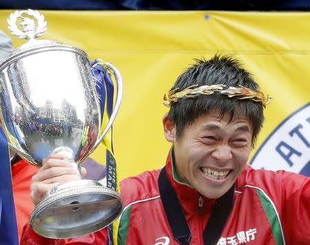 Apr 16, 2018; Boston, MA, USA; Yuki Kawauchi of Japan holds up the trophy after winning the 2018 Boston Marathon. Mandatory Credit: Winslow Townson-USA TODAY Sports