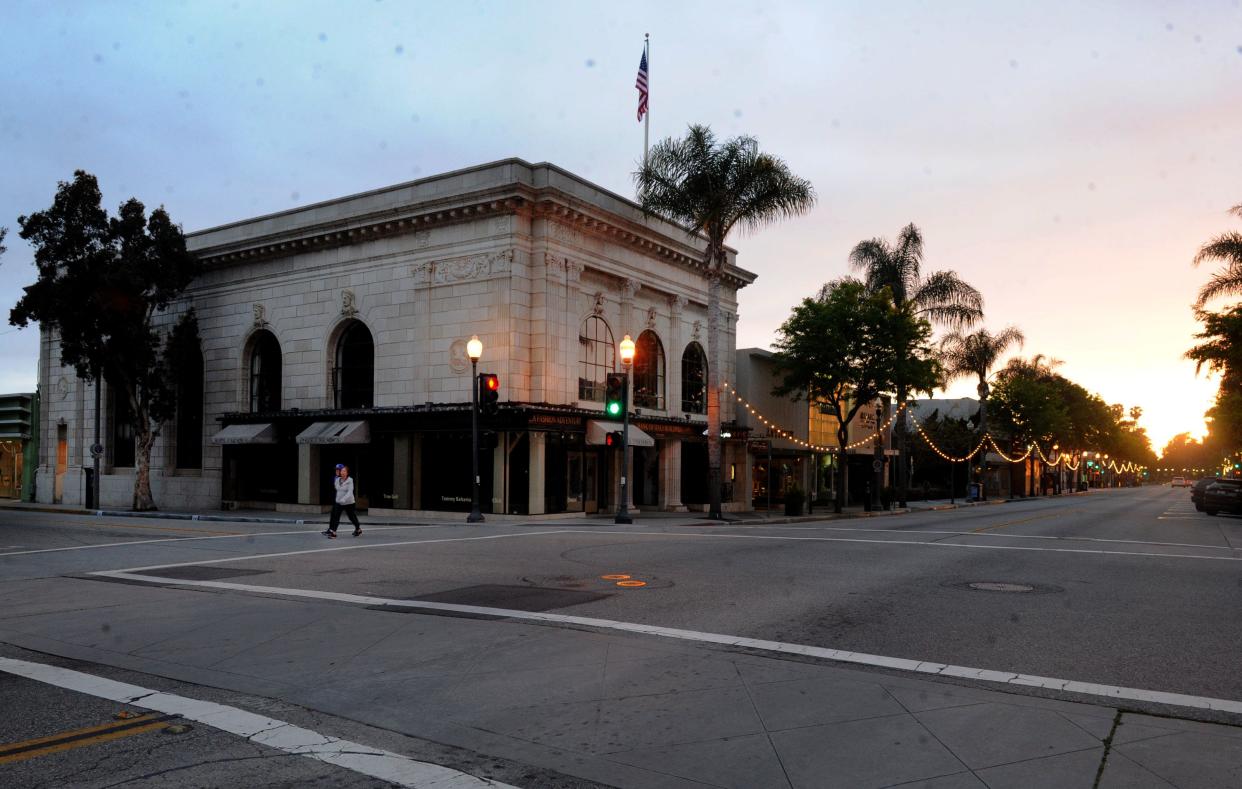 People walk near the Bank of Italy building on Main Street in downtown Ventura on Saturday, April 4, 2020.