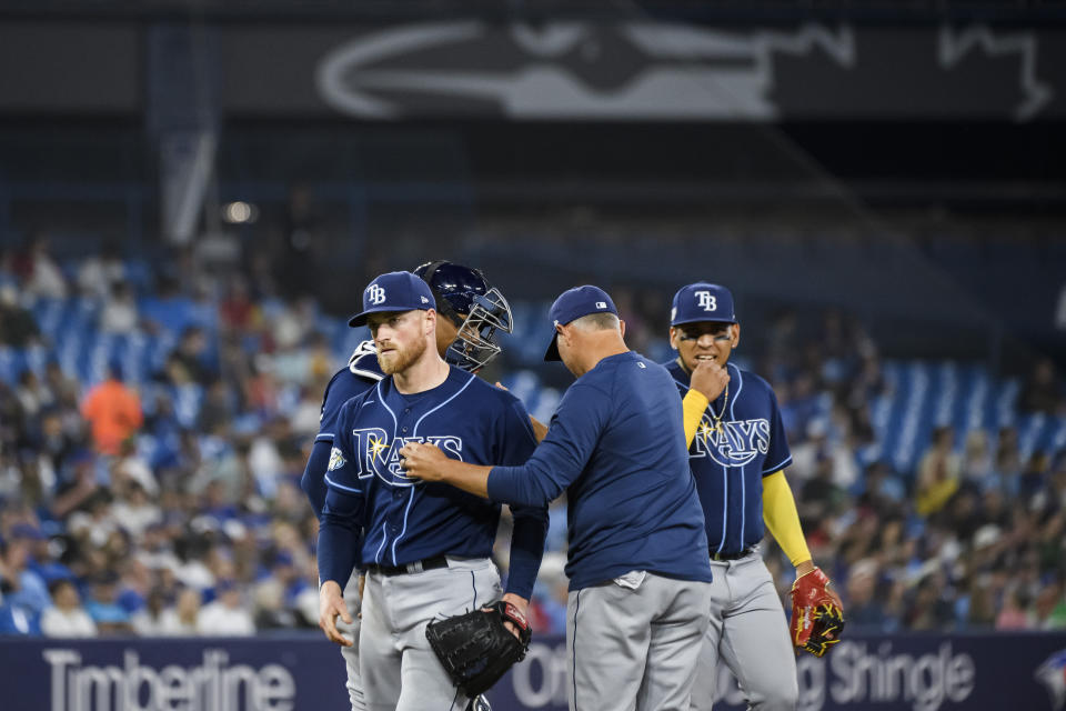 Tampa Bay Rays starting pitcher Drew Rasmussen (57) is removed by manager Kevin Cash during the fifth inning of the team's baseball game against the Toronto Blue Jays on Friday, April 14, 2023, in Toronto. (Christopher Katsarov/The Canadian Press via AP)