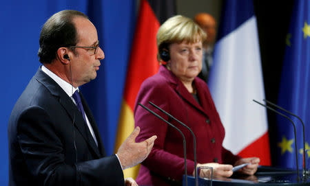 German Chancellor Angela Merkel and French President Francois Hollande address a news conference after talks on a stalled peace plan for eastern Ukraine at the chancellery in Berlin, Germany, October 20, 2016. REUTERS/Hannibal Hanschke