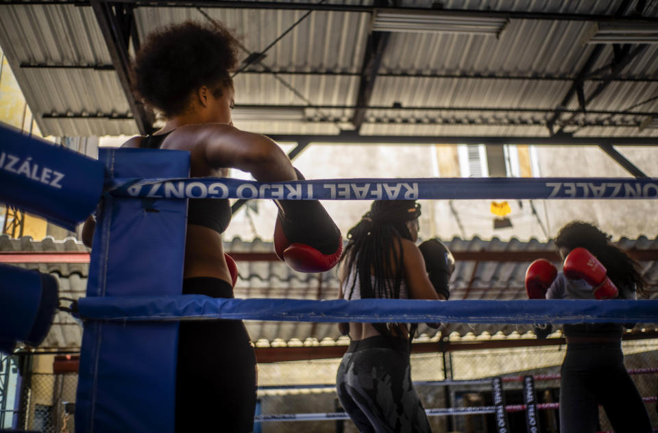 Boxer Giselle Bello Garcia, left, watches as fellow female boxers train in Havana, Cuba, Monday, Dec. 5, 2022. Cuban officials announced on Monday that women boxers would be able to compete for the first time ever. (AP Photo/Ramon Espinosa)