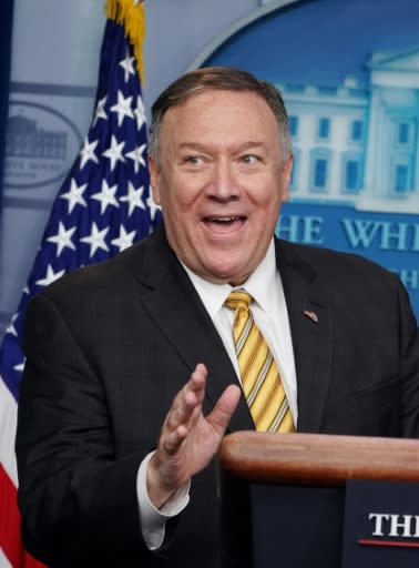 A smiling Secretary of State Mike Pompeo addresses reporters after the departure of national security advisor John Bolton